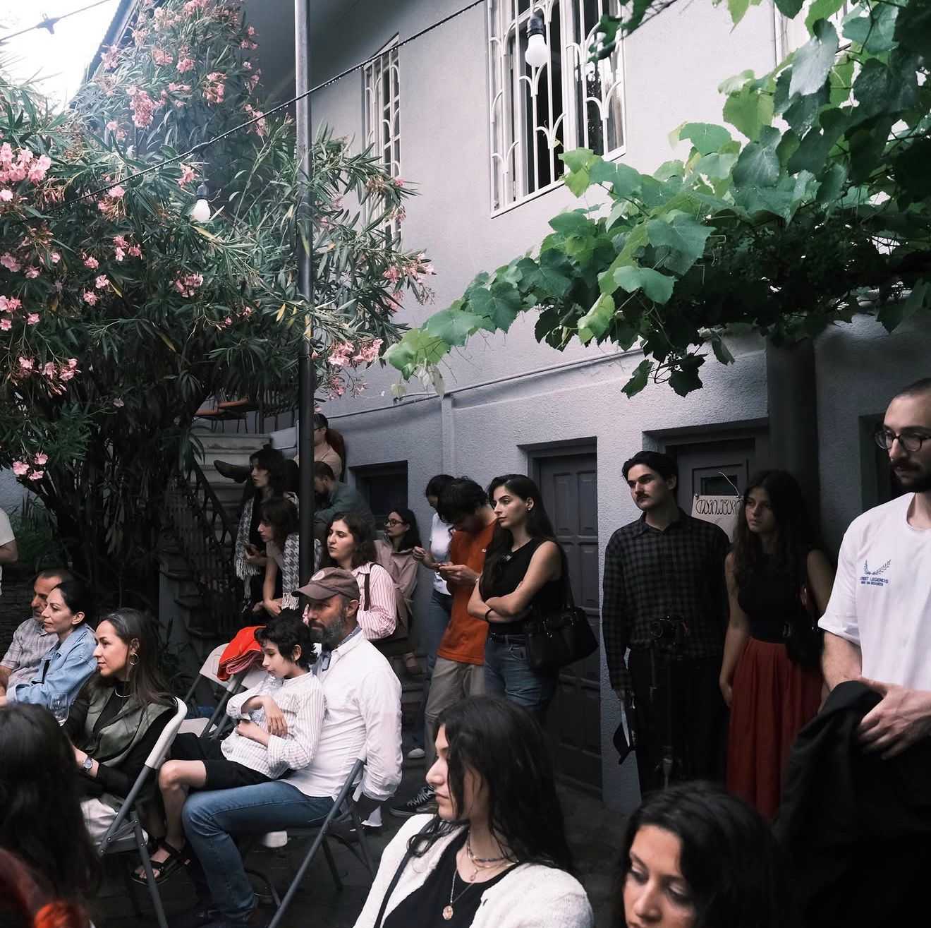 Another evening frame with the courtyard audience